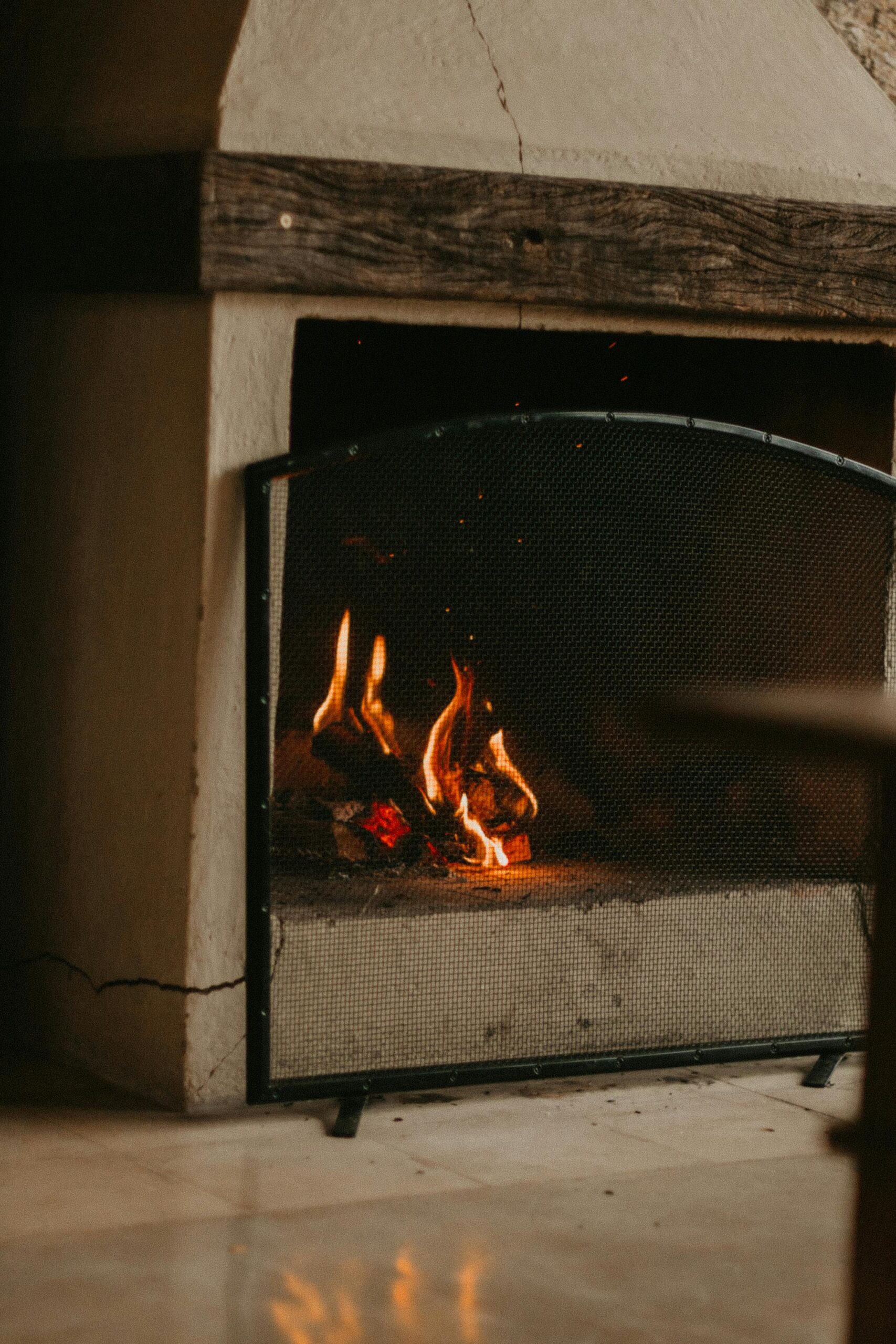 Warm and inviting fireplace with glowing logs, perfect for a cozy home atmosphere.