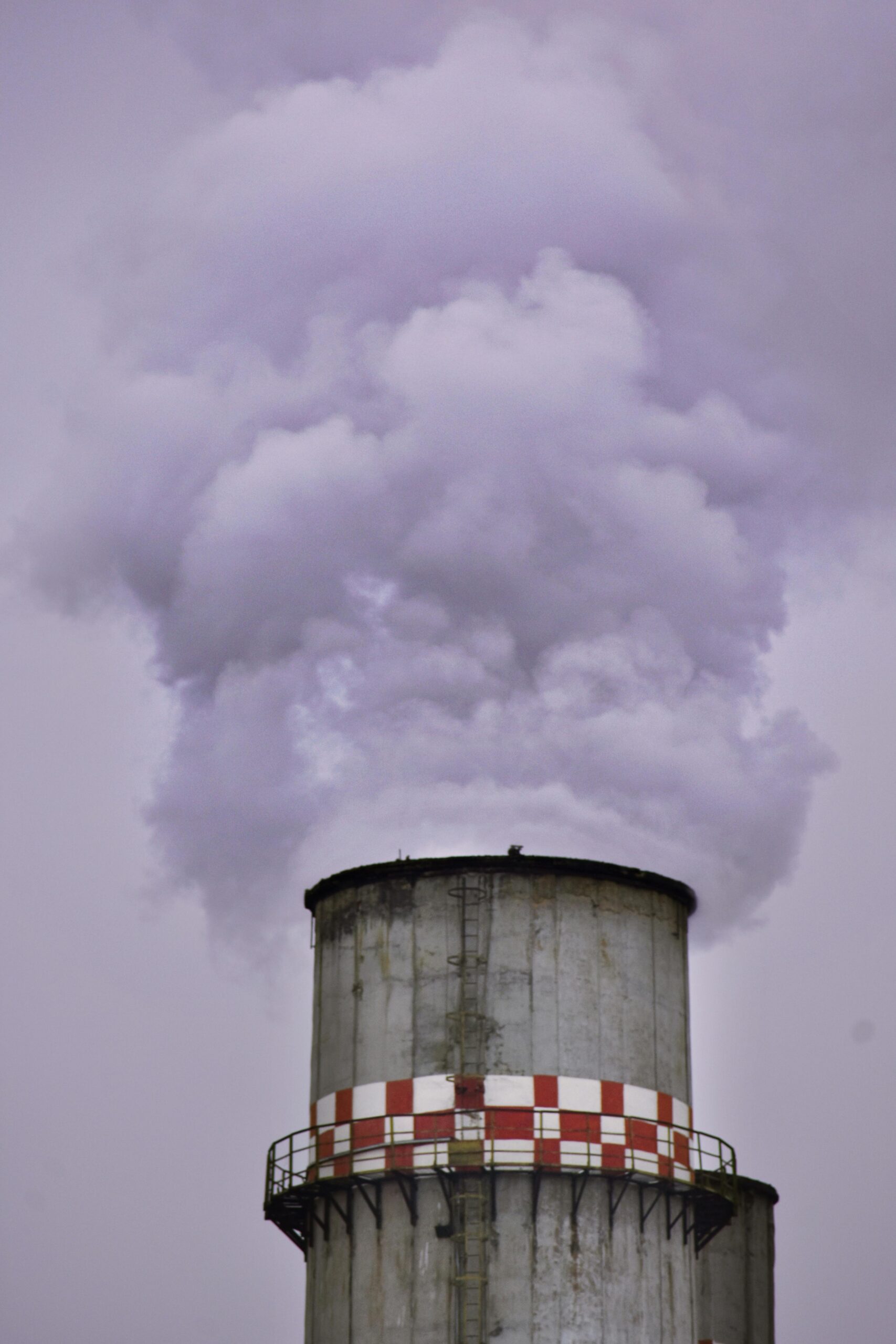 A close-up view of a factory chimney emitting thick smoke, highlighting industrial pollution.